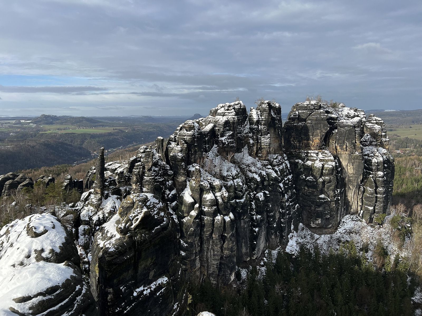 Snow-dusted sandstone towers of the Schrammsteine in Saxon Switzerland National Park in winter