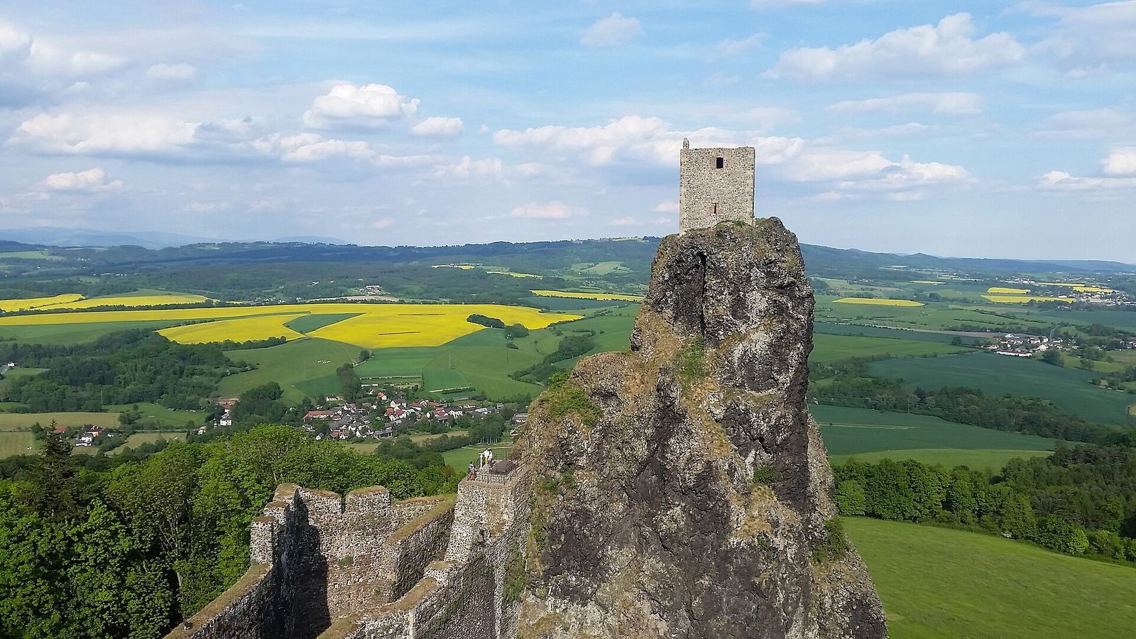 The Panna tower of Trosky Castle on its basalt pinnacle above the fields and villages of Bohemian Paradise